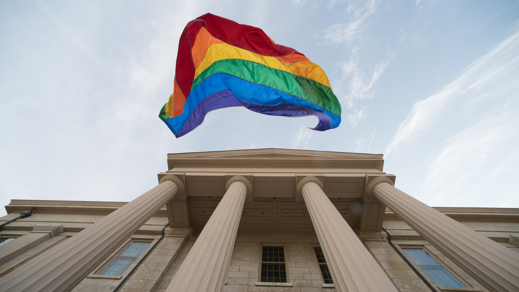 Pride Flag falling from the Old Capitol
