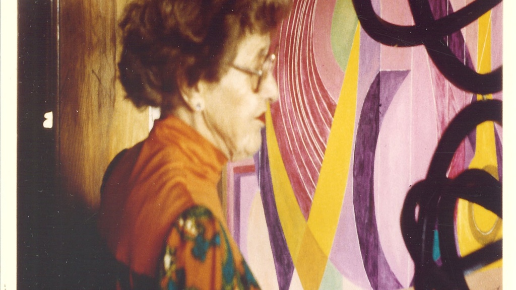 Drewelowe standing in front of her painting in the 1980s